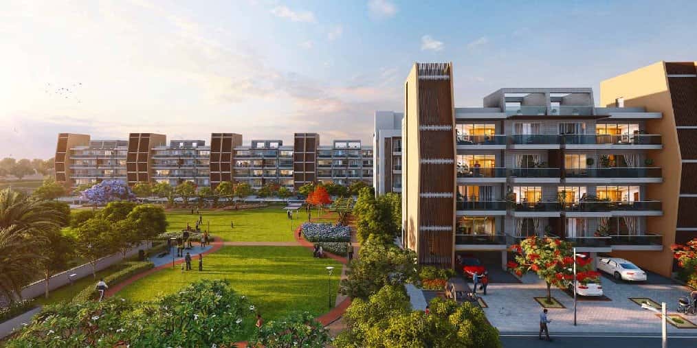 Adani Samsara Vilasa — low-rise residences beside a landscaped lawn